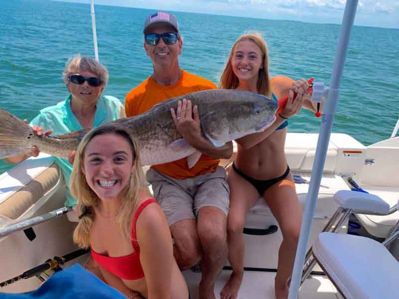 happy anglers with a cobia