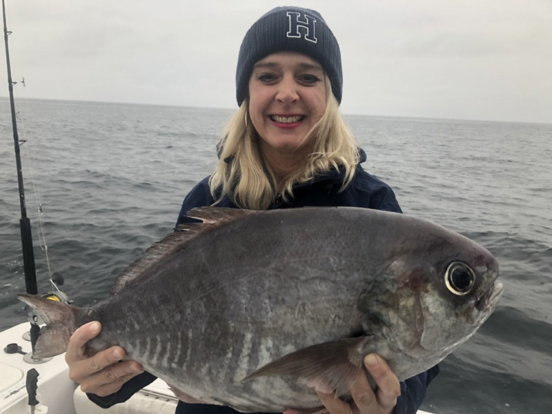 woman angler holds a barrelfish