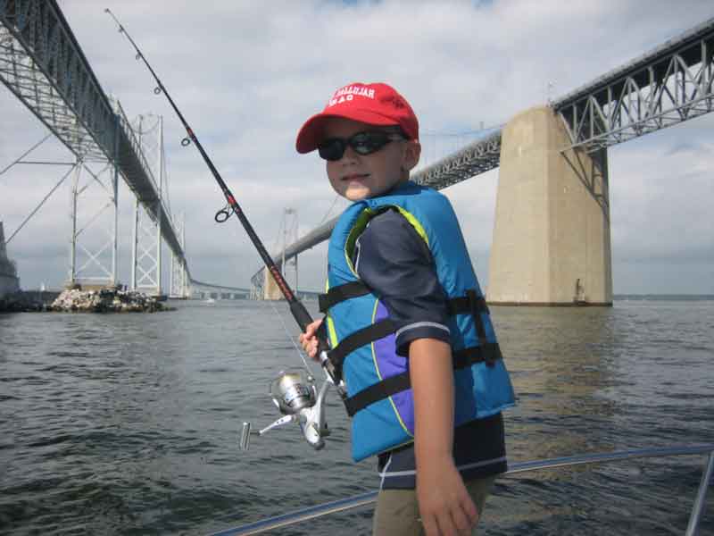 kid fishing near the bay bridge