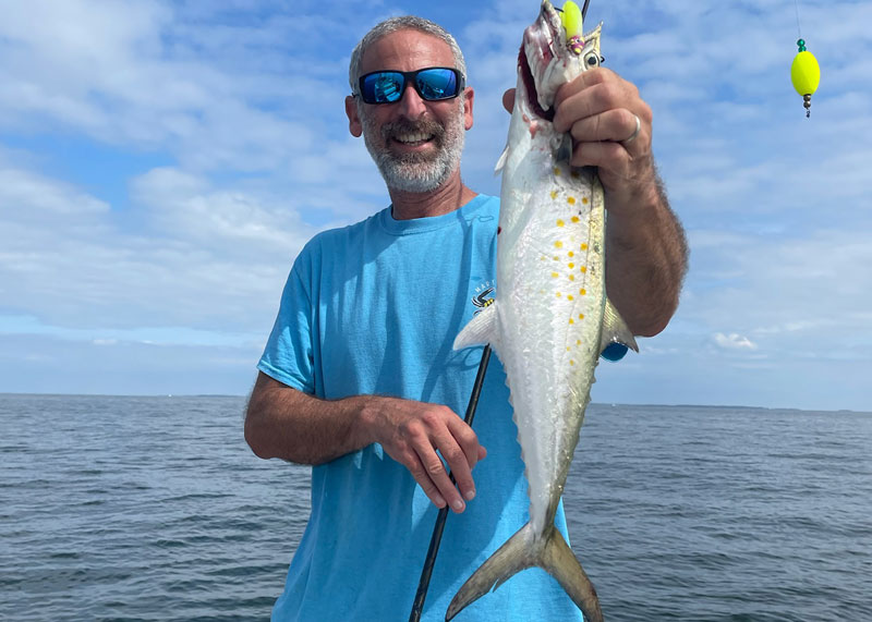 angler with a spanish mackerel caught on chesapeake bay