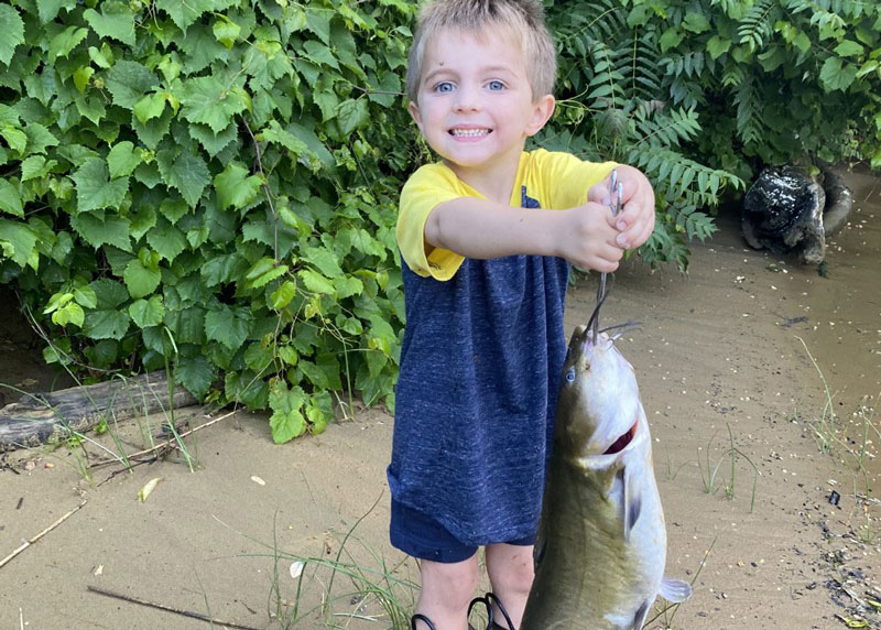 kid with a catfish