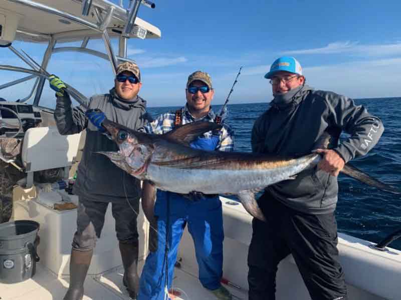 anglers with a swordfish caught day dropping