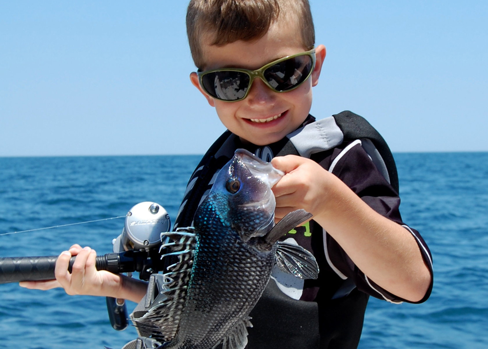 grandson fishing for sea bass