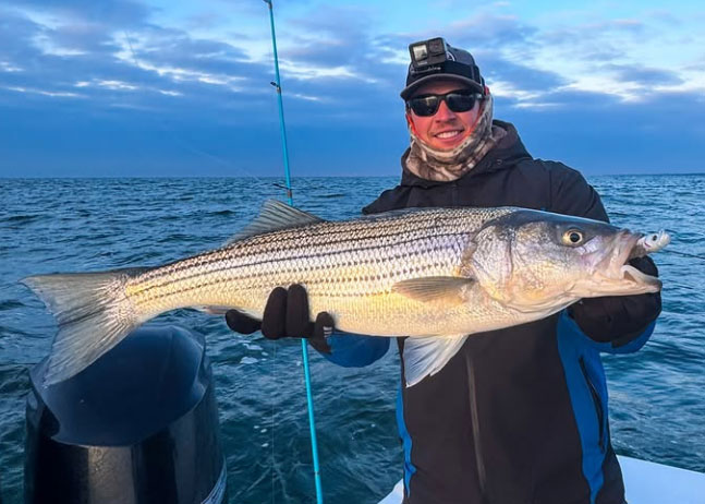 our fishing report editor with a big striped bass