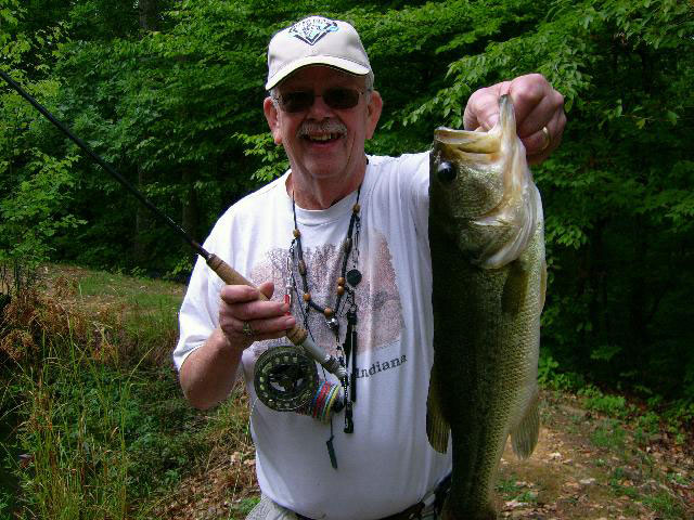 fly fisherman with a bass
