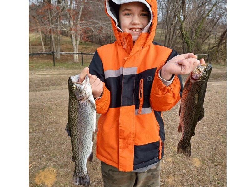 youth angler with a catch of trout