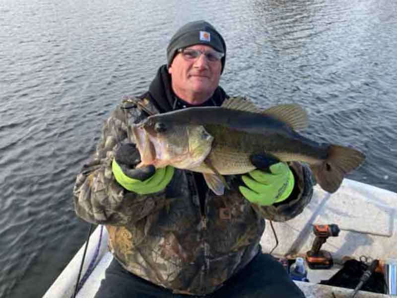big largemouth bass held up by angler