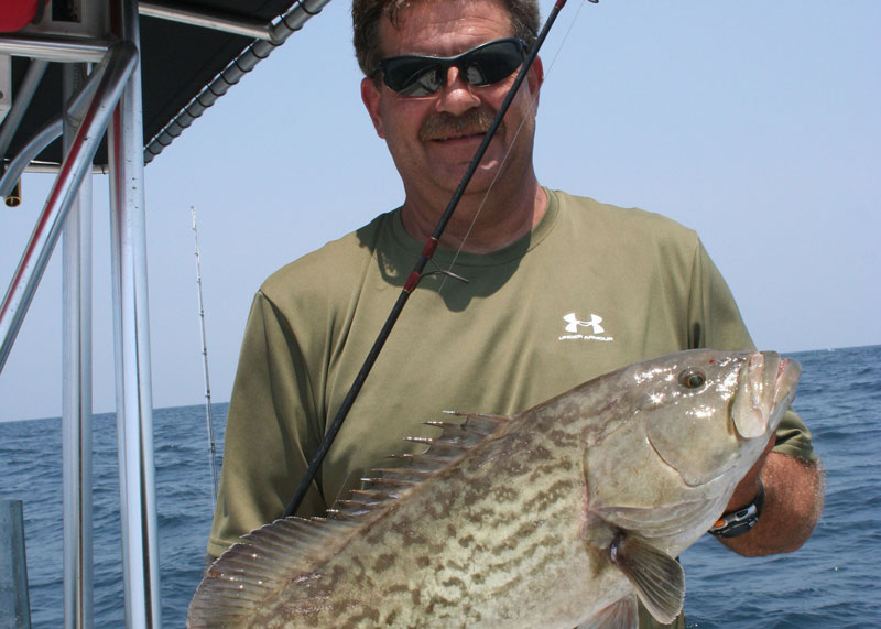 angler with a gag grouper