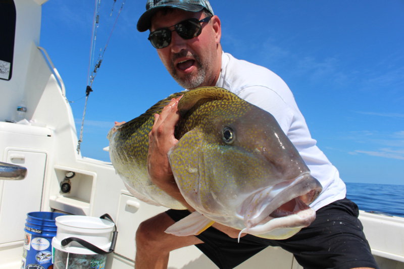 angler with a golden tilefish he caught deep drop fishing