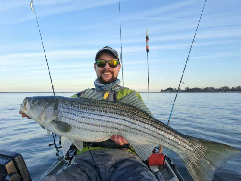 kayak angler with a trophy striped bass