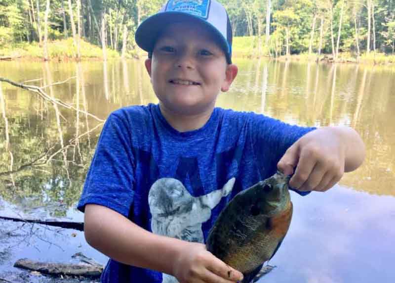 kid with a bluegill he caught