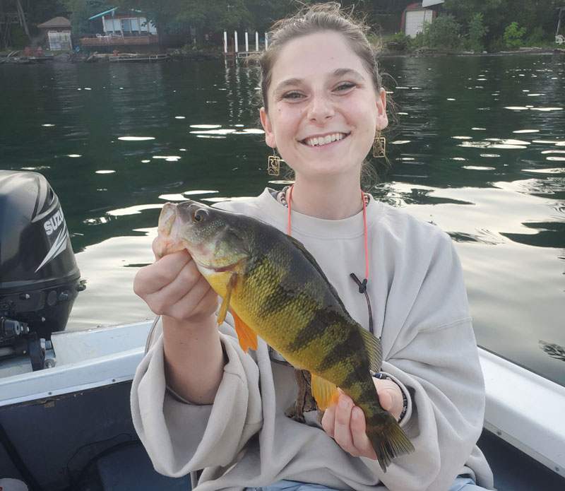 angler with a perch she caught on a drop-shot rig