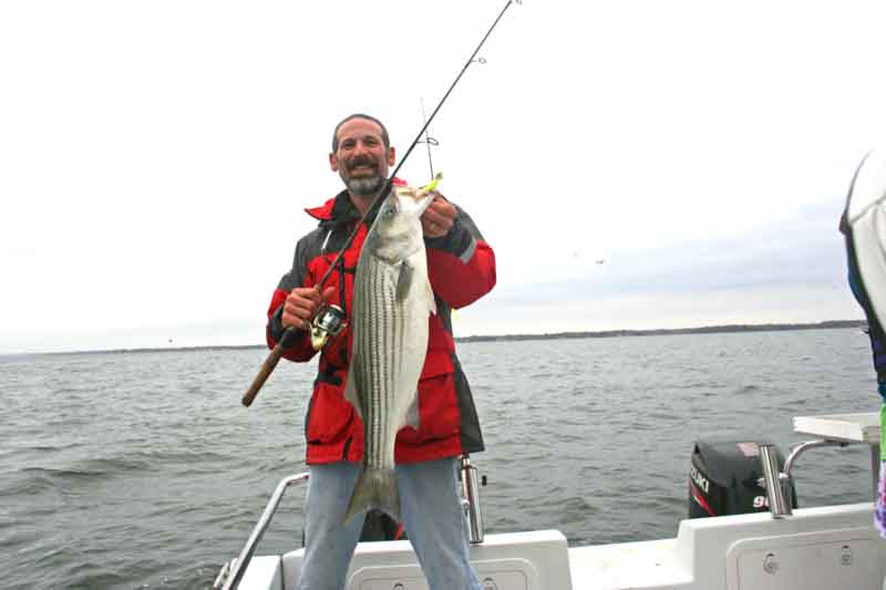 angler with a rockfish caught near an artificial reef
