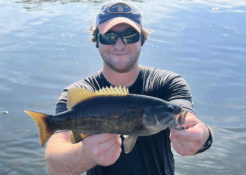 angler with a smallmouth bass