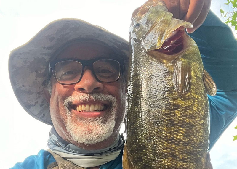 angler selfie with a smallmouth bass