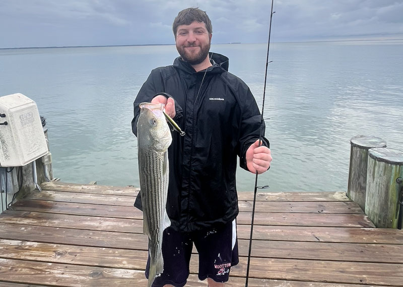 adam with a nice striper he caught on a lure