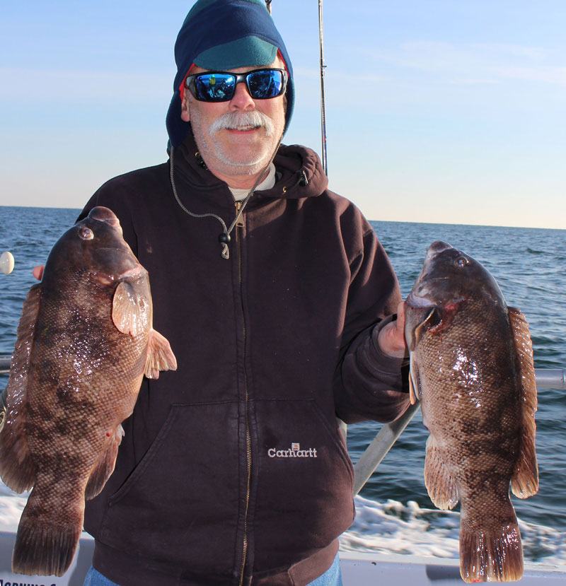 angler holding up tautog fish