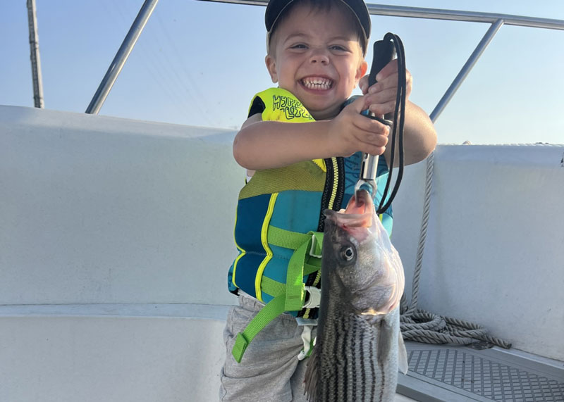 young kid with a rockfish
