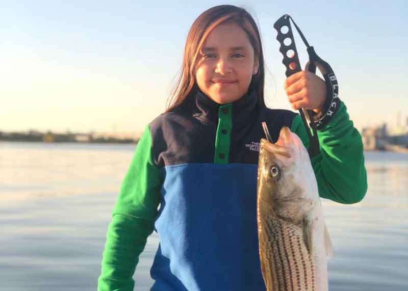 girl caught a rockfish in the chesapeake