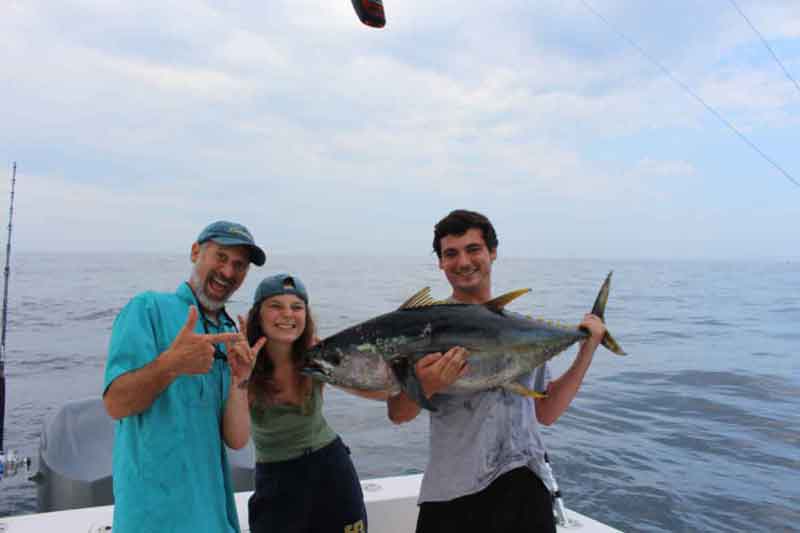 happy anglers with yellowfin tuna